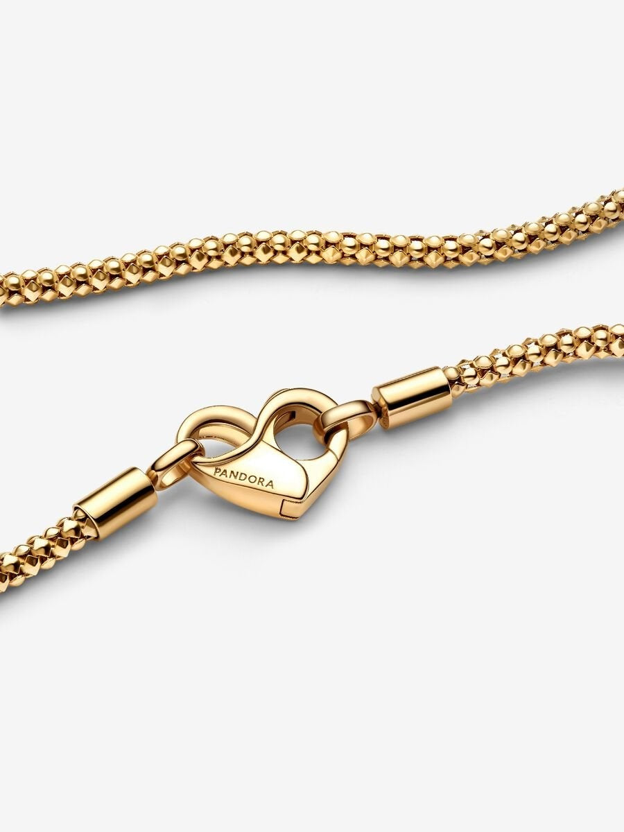 Gold Necklace with a heart-shaped clasp on a white background