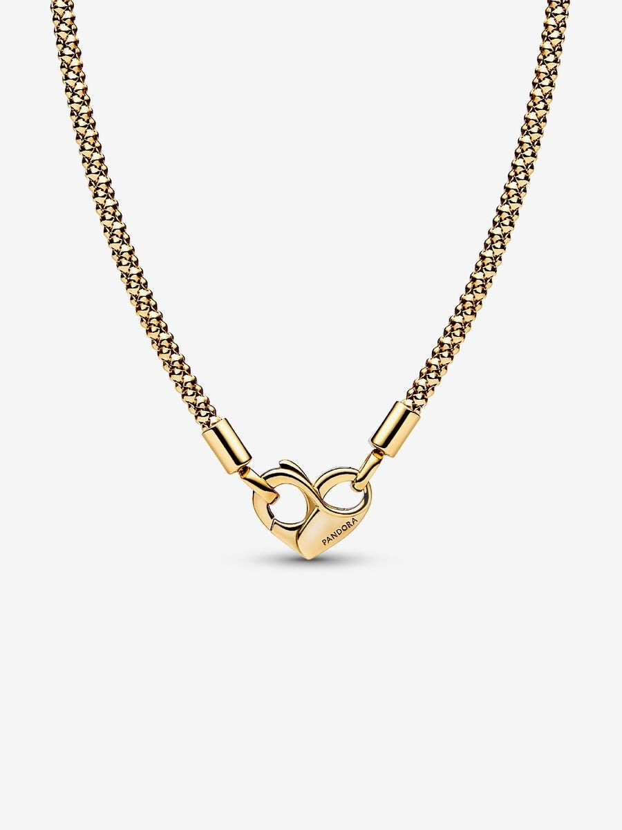 Gold necklace with a unique clasp design on a white background